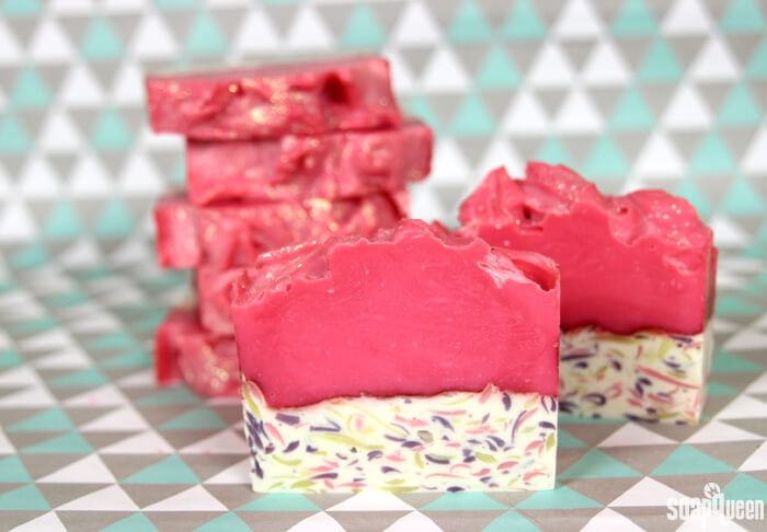 This cold process soap features a hot pink color palette, lots of glitter and a confetti layer to create an eye catching bar. 