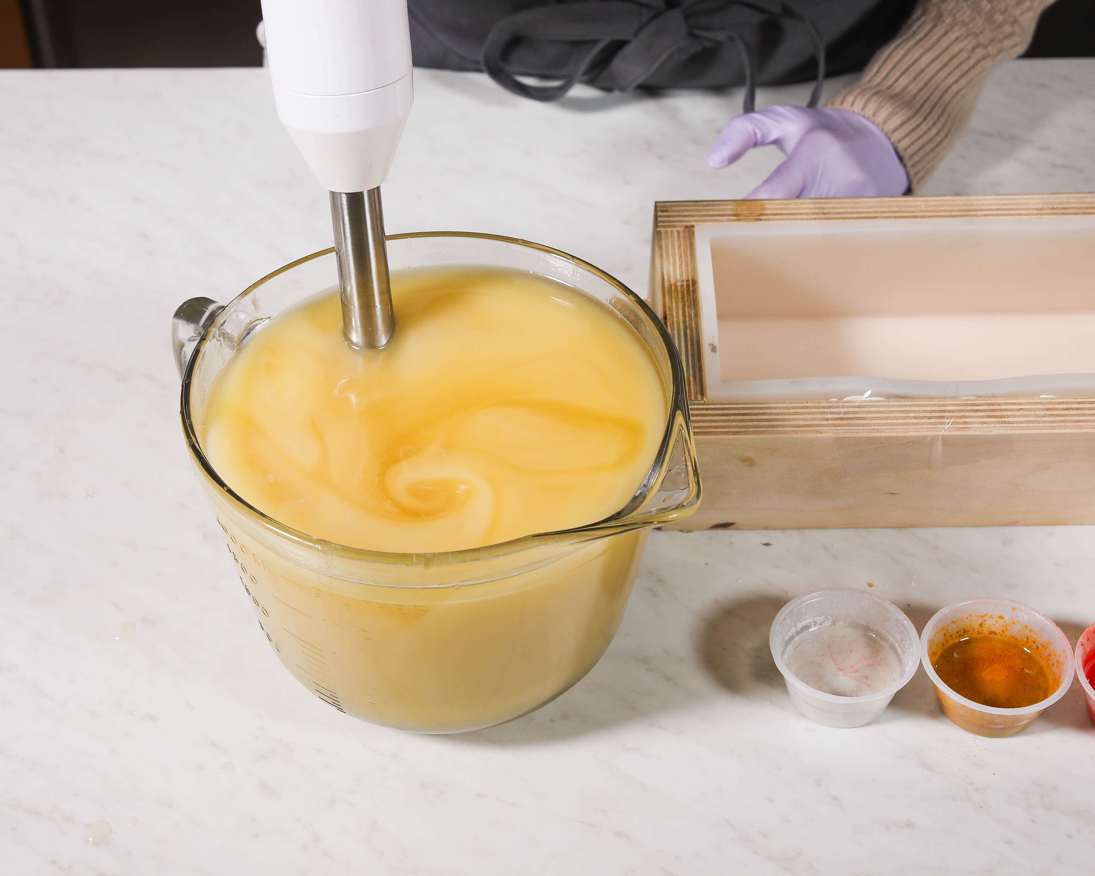 Stick blend to light trace Glass container full of lightly traced cold proess soap