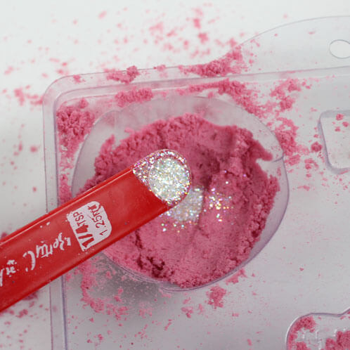 This bath bomb has hidden glitter inside. See how it's made in this tutorial!